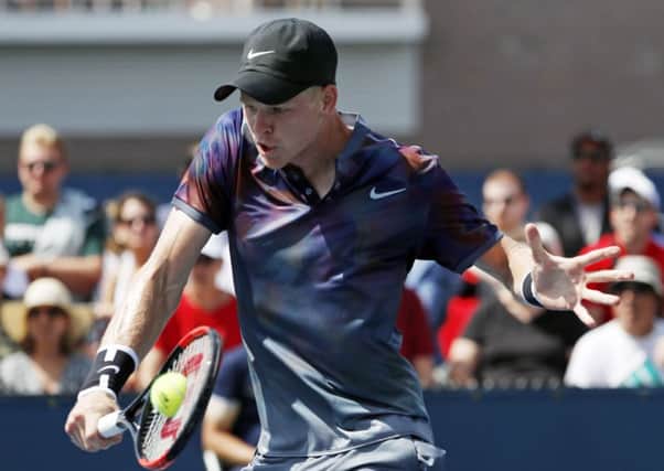 SAFELY THROUGH: Kyle Edmund returns a shot from Robin Haase. Picture: AP/Michael Noble