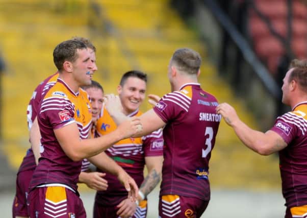 Batley Bulldogs' players celebrate scoring one of their tries against Bradford Bulls at Odsal. Picture: James Hardisty.