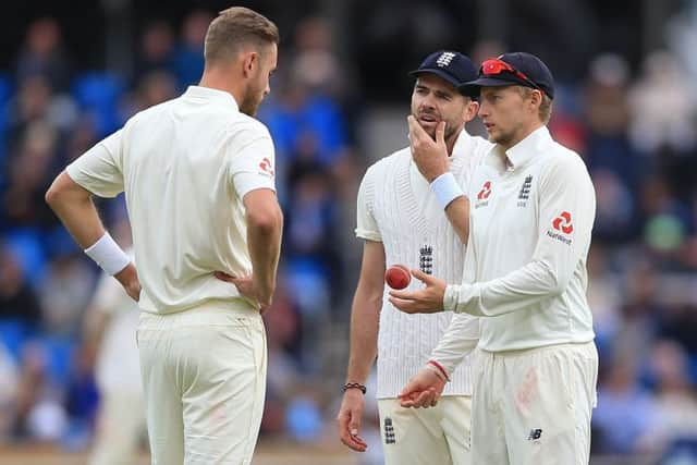 FRUSTRATED: England's captain Joe Root (right) talks to Stuart Broad (left) and James Anderson (centre) during day five. Picture: Nigel French/PA