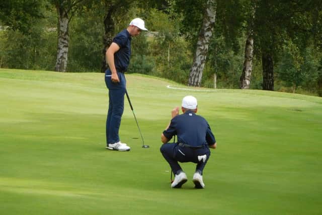 James Swash (Middlesbrough) and Ben Schmidt (Rotherham) check out the line of a putt.
