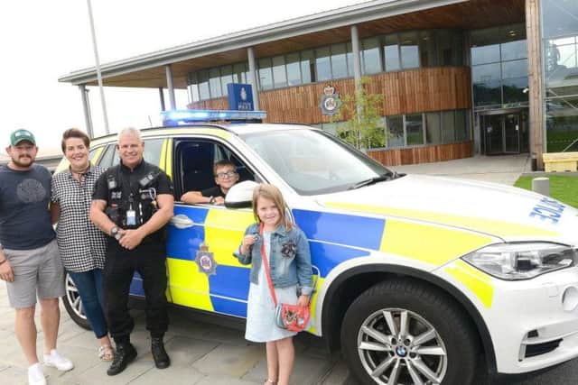 Bailey Walton with PC Paul Feather, and mum Liz, dad Tom and sister Lola.