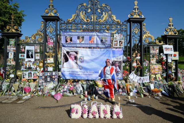 Flowers and tributes mark the 20th anniversary of the death of Diana, Princess of Wales, outside Kensington Palace in London.