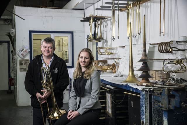 CHINA SALES DRIVE: Rath Trombones founder, Mick Rath, with Chamber
International executive, Lydia Sykes, at the companys workshop in Honley, West
Yorks.