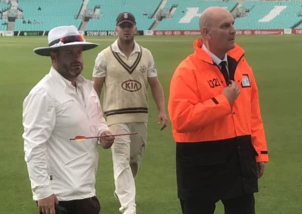 Picture taken with permission from the twitter feed of @topmanjem of a match official holding an arrow that was fired on to the pitch at the Kia Oval during a County Championship clash between Surrey and Middlesex. 
PIC: PA