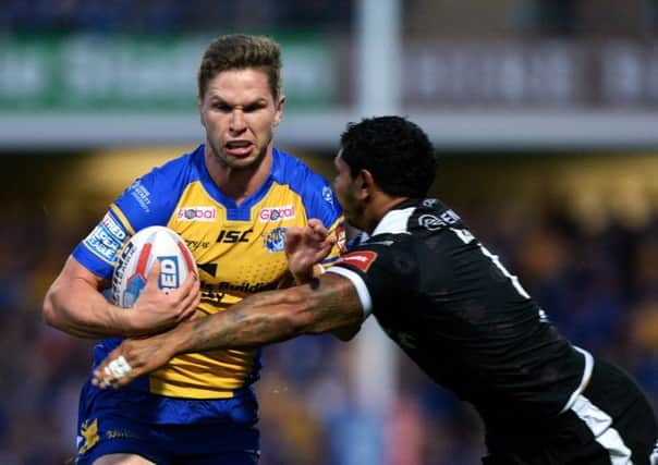 Matt Parcell is held by Carlos Tuimavave at Headingley.  Picture: Bruce Rollinson