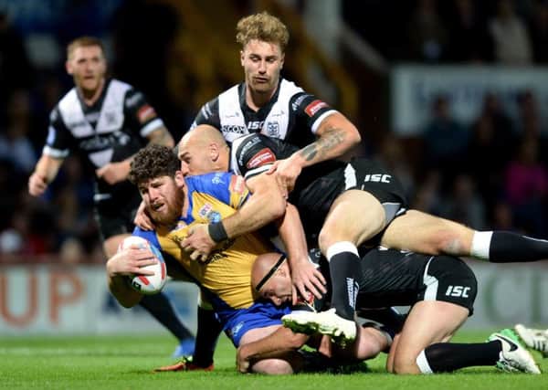 In top form: Leeds Rhinos' Mitch Garbutt is stopped by Danny Houghton and Gareth Ellis.
Picture: Bruce Rollinson