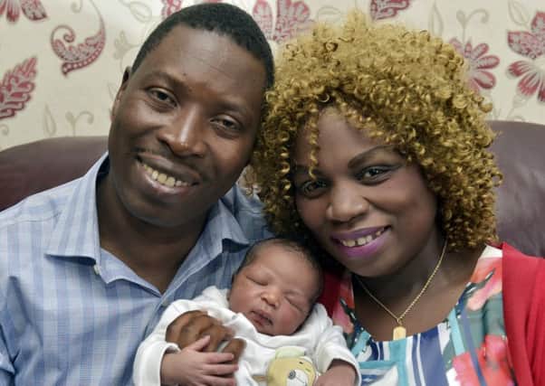 Faustin Rukundo and Violette Uwamahoro with baby Gideon at their home in Beeston