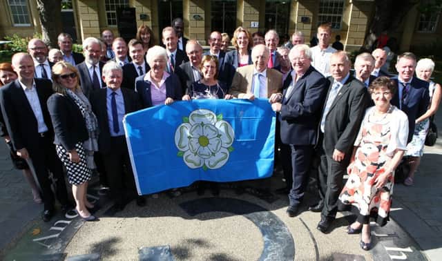 An image of senior council figures holding the Yorkshire flag was released with the latest statement on devolution talks