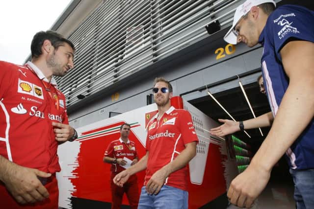 CATCH ME IF YOUC AN: Ferrari driver Sebastian Vettel is in Lewis Hailton's sights. Picture: AP/Luca Bruno