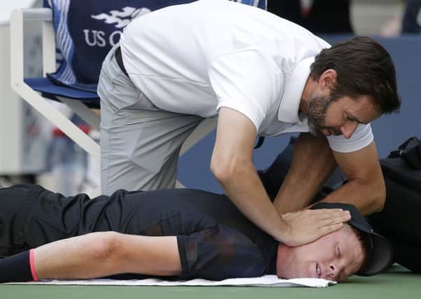 Kyle Edmund is worked on by a trainer during a medical time out.
