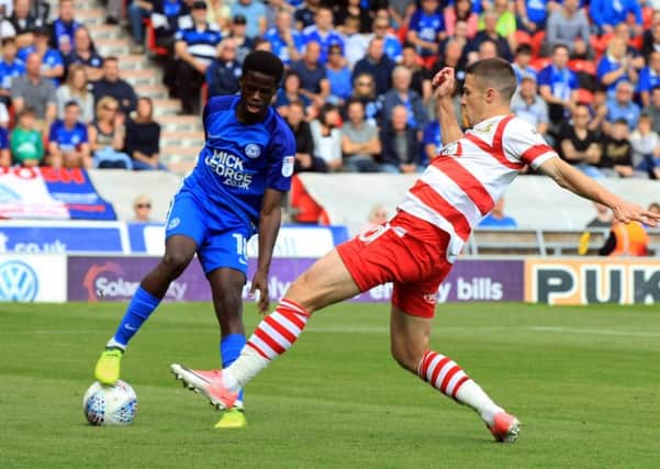 Doncaster Rovers' Tommy Rowe battles for possession against Peterborough. Picture: Chris Etchells