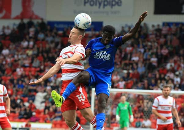 Doncaster Rovers' Tommy Rowe wins a head under pressure against Peterborough. Picture: Chris Etchells