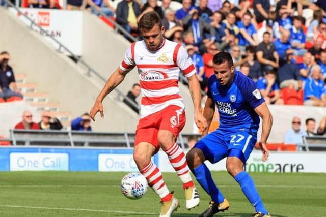 Doncaster Rovers' Andy Butler shields the ball under pressure against Peterborough this afternoon. Picture: Chris Etchells