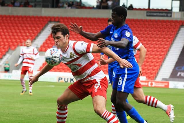 Doncaster Rovers' John Marquis shields the ball. Picture: Chris Etchells