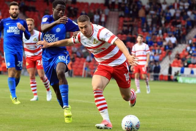Trying to break through: Doncaster Rovers' Tommy Rowe in action against Peterborough. 
Picture: Chris Etchells