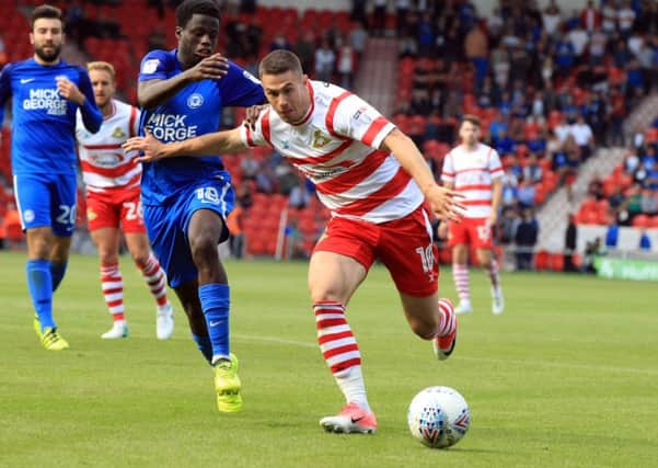 Trying to break through: Doncaster Rovers' Tommy Rowe in action against Peterborough. 
Picture: Chris Etchells