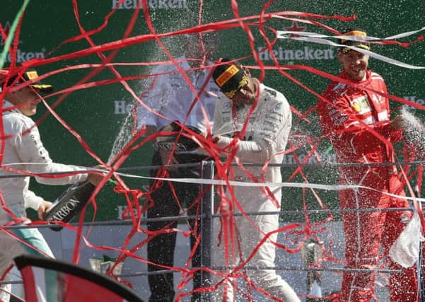 Celebrations: Mercedes driver Lewis Hamilton sprays the bubbly.