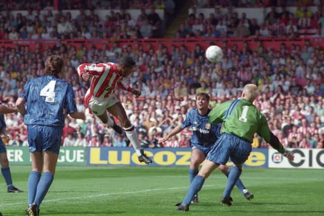 GET IN: Sheffield United's Brian Deane climbs highest to score the first-ever Premiership goal, against Manchester United on August 15, 1992.