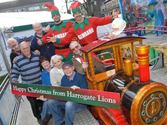Harrogate at Christmas last year: Brian Dunsby with The Gambaru elves Jonathan Walker and Matthew Goodall , Steve Scarre, and members of The Harrogate Lions Eric Wright, Carol Houseman, Eve Nelson, Steve Caldwell and Stewart Reid.