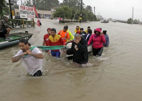 Devastation: Evacuees trying to escape the floodwaters in Houston. (AP).