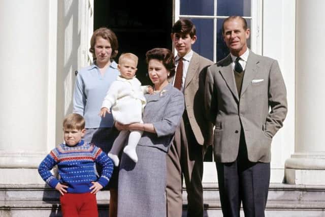The Queen holding Prince Edward, with the Duke of Edinburgh, the Prince of Wales, Princess Anne and Prince Andrew
