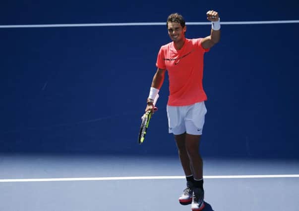 Rafael Nadal waves to fans after winning his match against Alexandr Dolgopolov at the US Open in New York. Picture: AP/Jason Decrow.