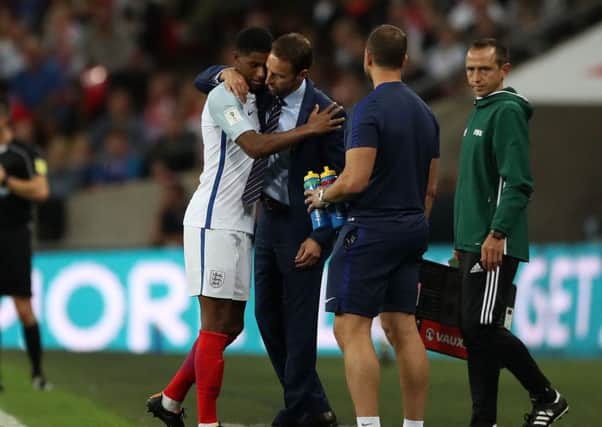 England's Marcus Rashford is hugged by manager Gareth Southgate as he is subbed at Wembley against Slovakia. Picture: Nick Potts/PA