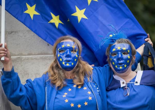 Protesters wearing European Union flag masks take part in an anti-Brexit demonstration outside the Houses of Parliament. PIC: PA