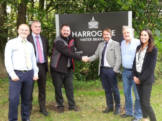 Its a deal - Transdev chief executive Alex Hornby shakes hands with Harrogate Spring Waters boss James Cain OBE. Also pictured are Nidderdale Chamber of Trades Keith Tordoff and Nicky Cain with Ben Mansfield, from Harrogate Bus Company  and Paul Chattwood of DalesBus.