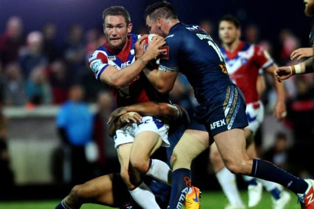 Wakefield's hooker Tyler Randell is tackled by Saints defence.
Picture: Jonathan Gawthorpe