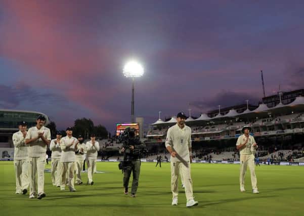 England's James Anderson (centre) is applauded off the pitch after reaching 500 Test wickets.