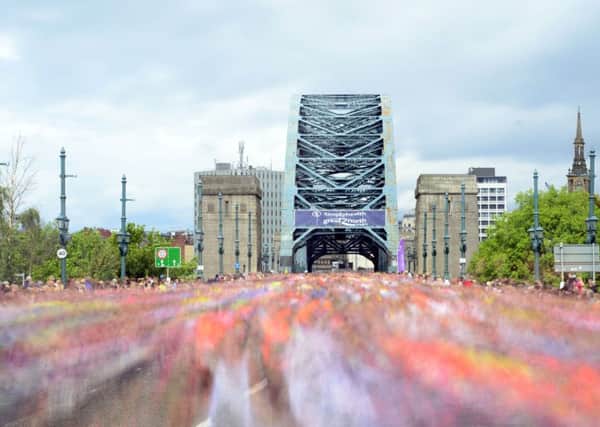 Runners make their way over the Tyne Bridge during the Great North Run in Newcastle. PIC: PA