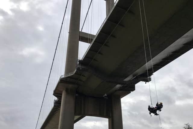 Jason Liversidge who has Motor Neurone Disease is pictured with his wife Liz, abseiling down the Humber Bridge, Hull. Picture by Simon Hulme