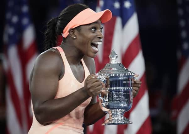 Sloane Stephens, of the United States, holds up the championship trophy after beating Madison Keys, of the United States, in the women's singles final of the U.S. Open tennis tournament. (AP Photo/Julio Cortez)