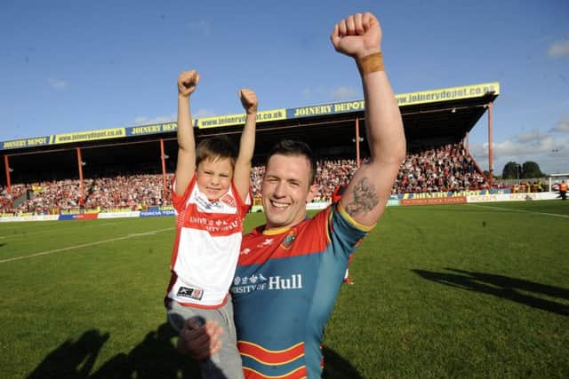 Shaun Lunt with his son Noah celebrates being promoted to the Super League. Picture by Simon Hulme