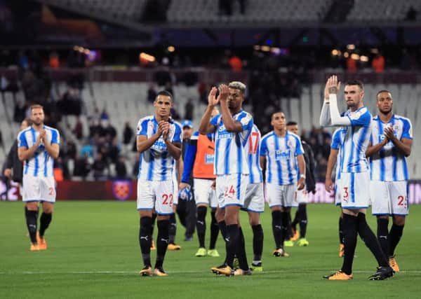Huddersfield Town players applaud the fans after the Premier League match at the London Stadium.