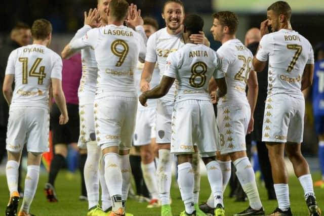 The Leeds United squad celebrate hitting top spot at full-time