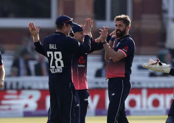 POPULAR GUY: Liam Plunkett is congratulated by his England team-mates after taking a wicket against in an ODI Ireland earlier this year. Picture: John Walton/PA