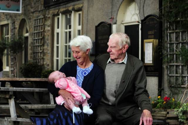 Community hub at the Swan Inn, Carleton. The village's oldest couple, Mary and Mick Hargreaves, pictured with one of the youngest, baby Anna Hirst.
