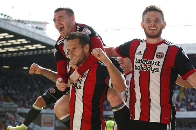 Jack O'Connell, right, celebrates with Billy Sharp and John Fleck after Sheffield United defetead Derby County. (Picture: Simon Bellis/Sportimage)