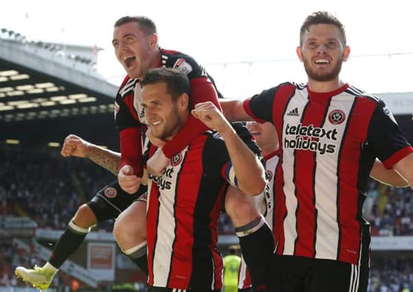 Jack O'Connell, right, celebrates with Billy Sharp and John Fleck after Sheffield United defetead Derby County. (Picture: Simon Bellis/Sportimage)