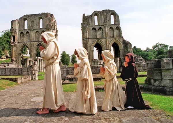 'Brother Thomas' Don Holton of Sheffied based Heuristics with 'Monks' from left Rebecca Kirby 7 yrs; Kerry 7yrs and Emma Goddard 6yrs at the 850th anniverary celebrations at Roche Abbey