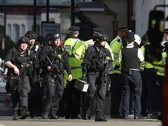 Armed police attend the scene in London this morning after a bomb exploded on the London Underground.