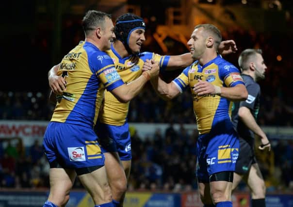 Danny McGuire celebrates scoring the Rhiinos second try with Ashton Golding and Rob Burrow.
