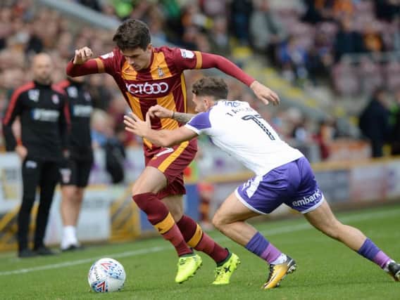Alex Gilliead and Jon Taylor challenge for the ball.
