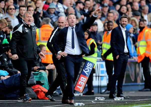 Millwall manager Neil Harris shouts instructions to his players during the Sky Bet Championship match at The Den.