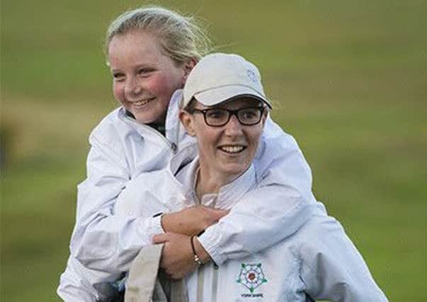 Rotherham's Olivia Winnings gives Yorkshire team-mate Mia Eales-Smith (Lindrick) a piggy-back after the victory over Hampshire (Picture: Leaderboard Photography).