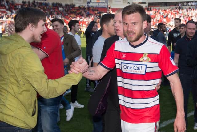 Doncaster Rovers Andy Butler celebrates promotion with the fans after the Sky Bet League Two match at the Keepmoat Stadium, Doncaster, last season. (Picture: PA)