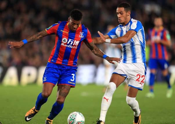 Crystal Palace's Patrick van Aanholt (left) and Huddersfield Town's Tom Ince battle for the ball . Picture: Adam Davy/PA