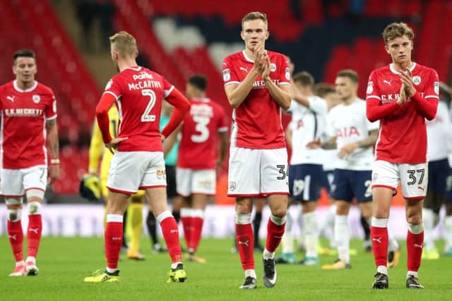 Barnsley's Ryan Hedges (centre) and Barnsley's Jared Bird (right) acknowledge the fans after the final whistle in the Carabao Cup, third round match at London. PRESS ASSOCIATION Photo. Picture: Jonathan Brady/PA